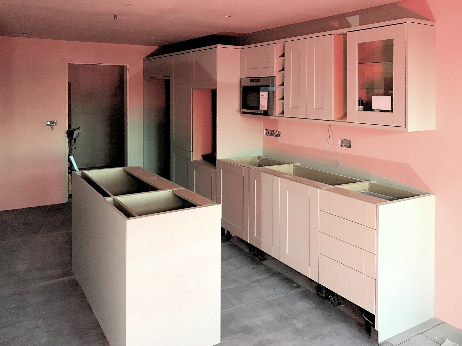 Kitchen with Island, Installation of island backing panels and high level microwave. Barnstaple North Devon