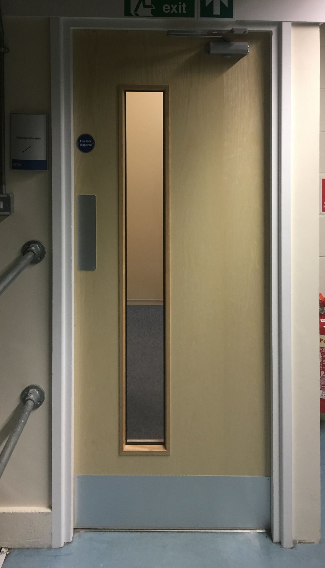 Old doors removed, installed replacement Ash doors with vision panels. New fire rated ironmongery fitted, correct signage, door closures and intumescent smoke seals for a North Devon Factory