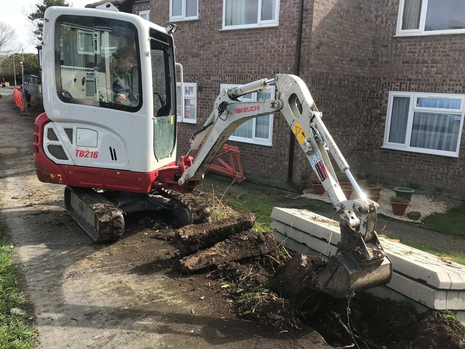 Excavation of concrete and bushes was completed with mechanical help.