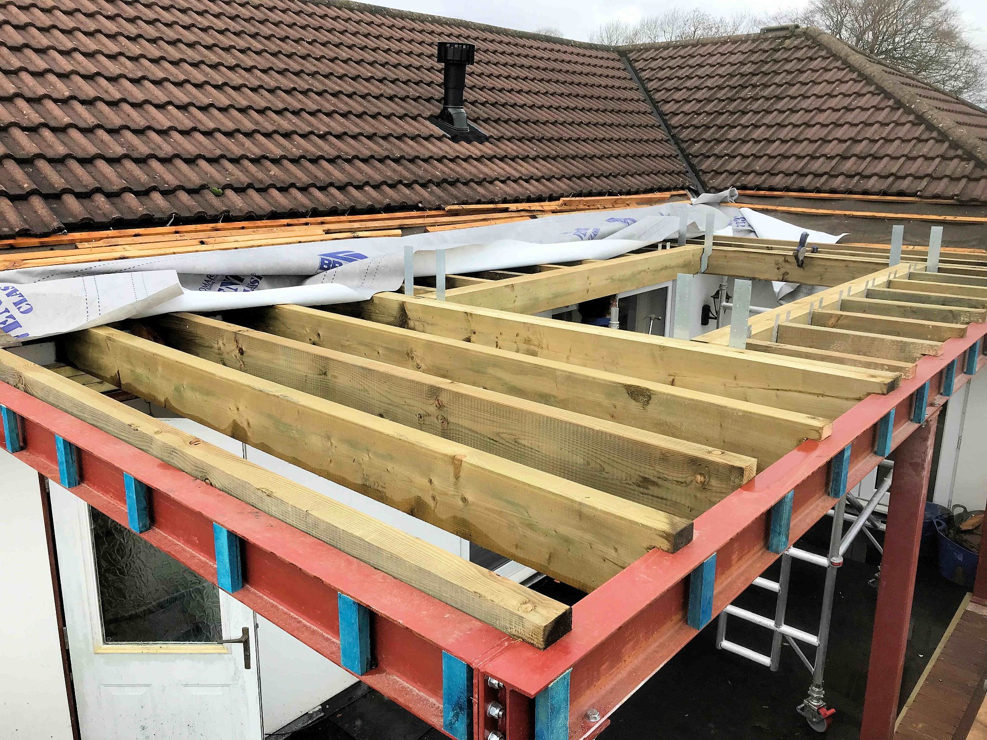 Construction of summer room on the first floor North Devon, joists installed at 400 centres, apertures created and fitted on joist hangers.