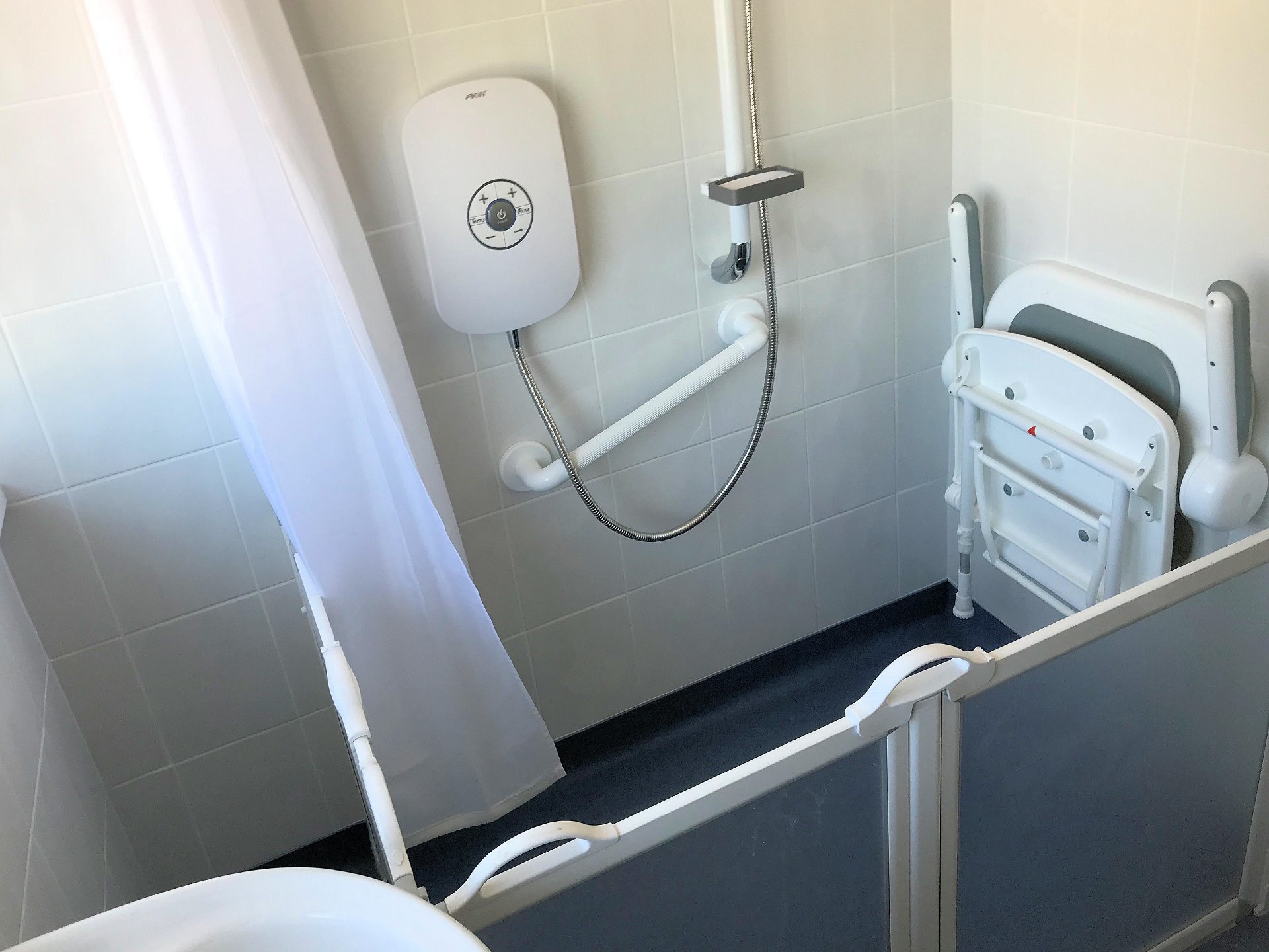 Adaption suit installed including easy use shower support handles gate access and fold down seat and shower curtain