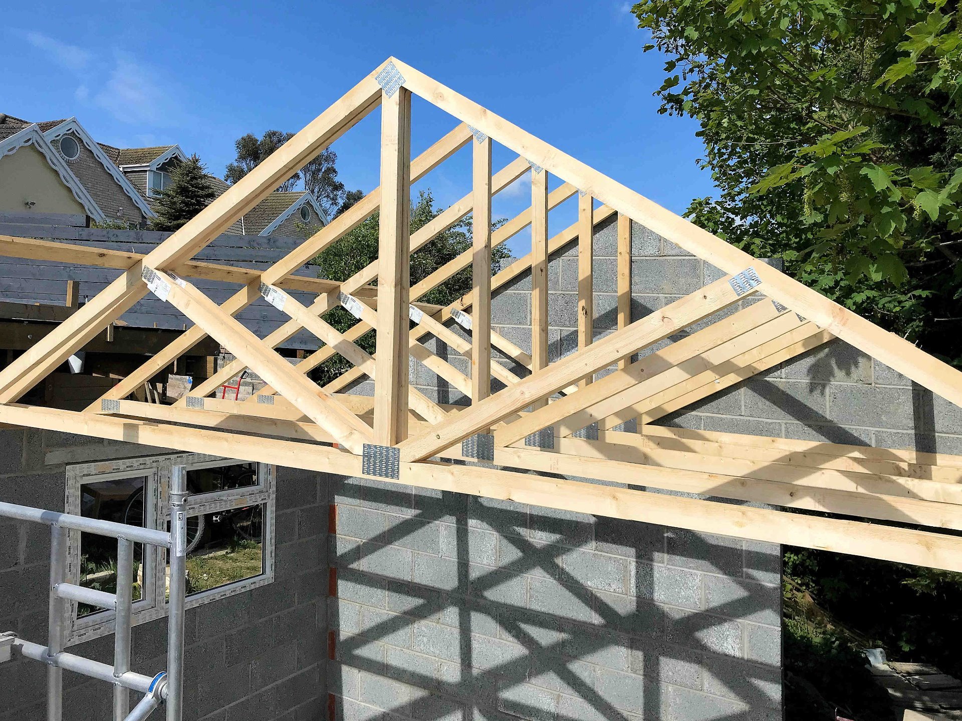 Garage roof trusses in place, cross braces installed. North Devon