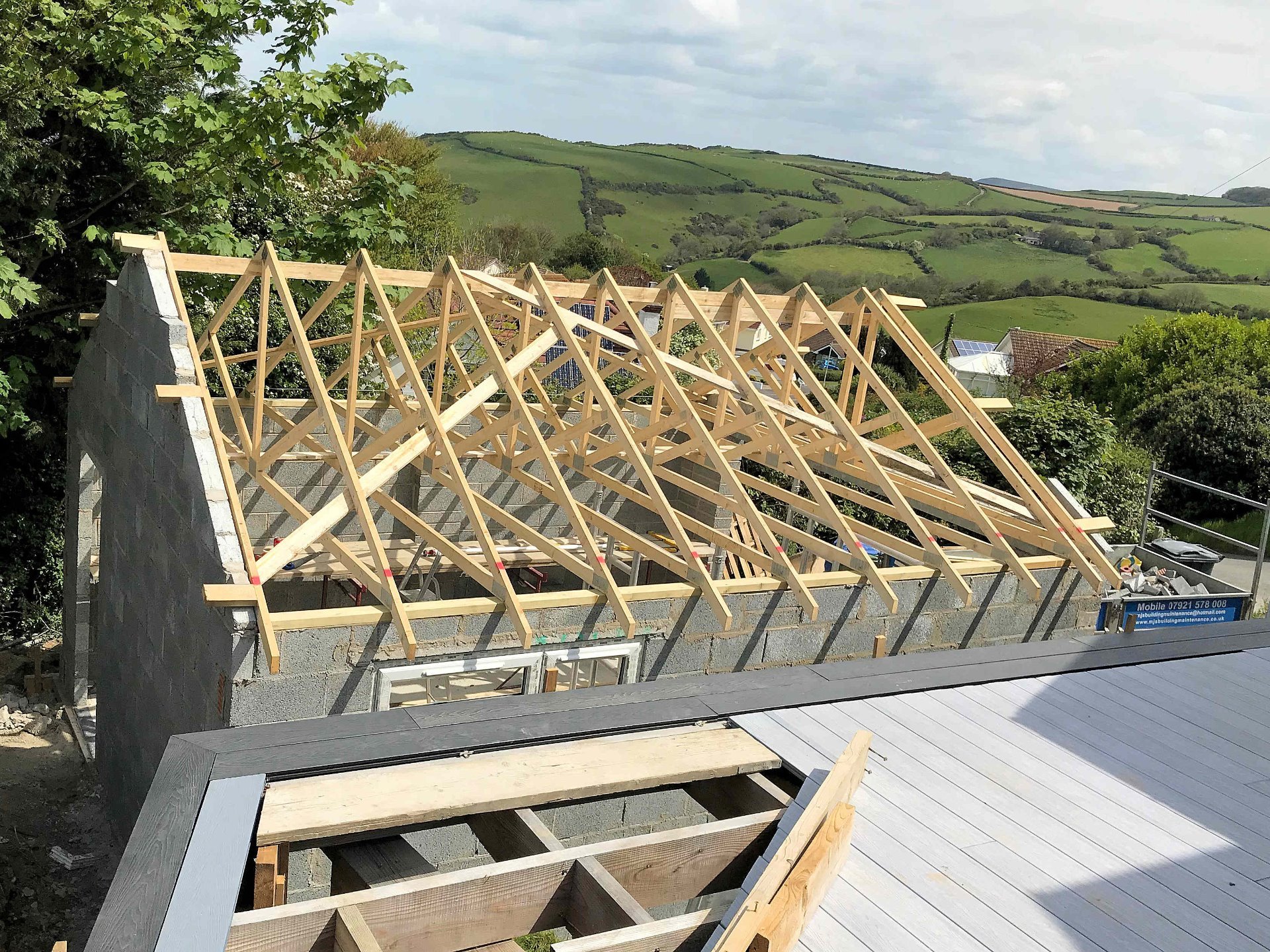 Garage roof trusses installed, first gable end build to full hight. North Devon