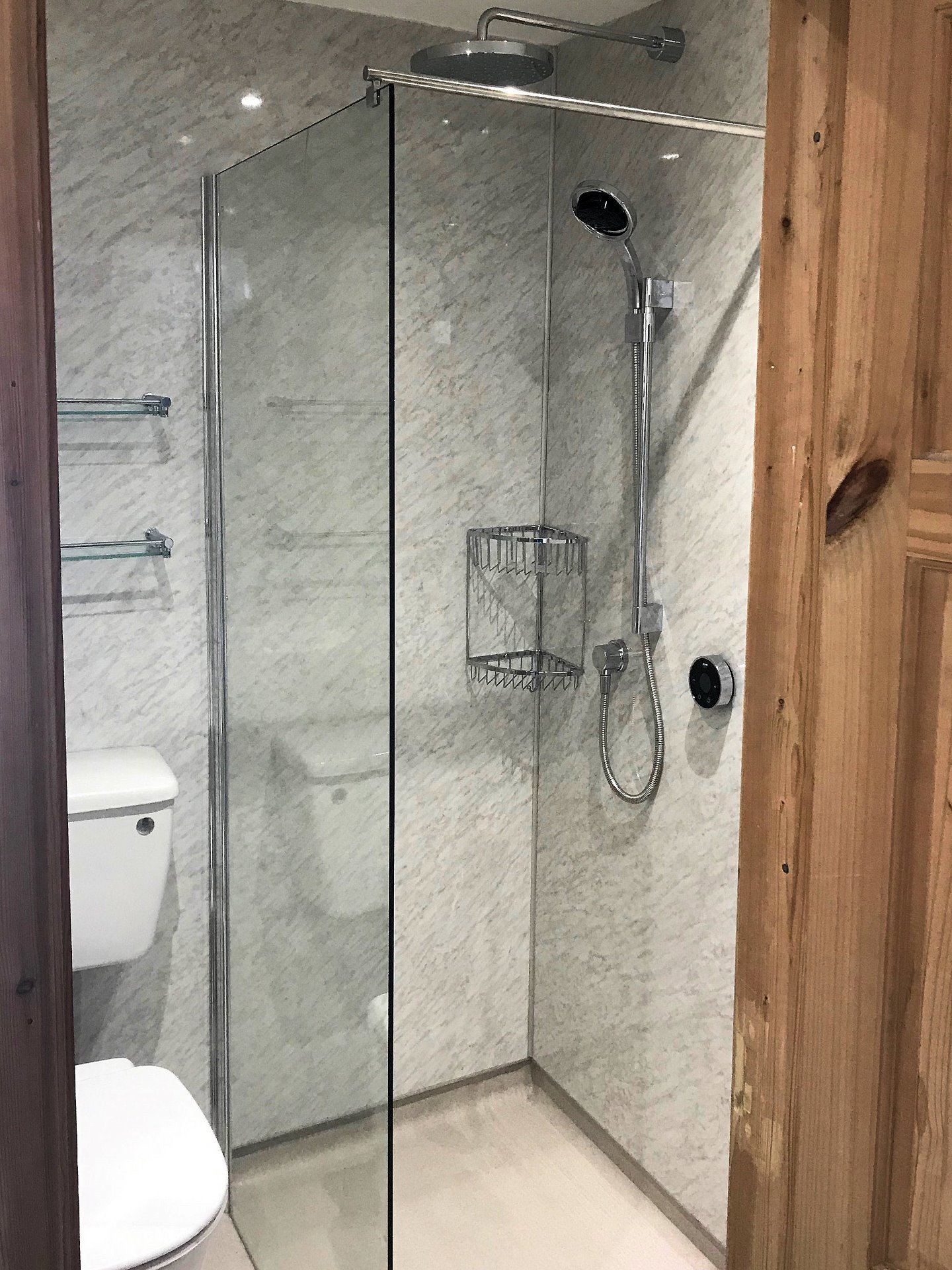12mm thick toughened safety glass frameless wetroom shower screen with chrome basket shower fittings. Barnstaple North Devon