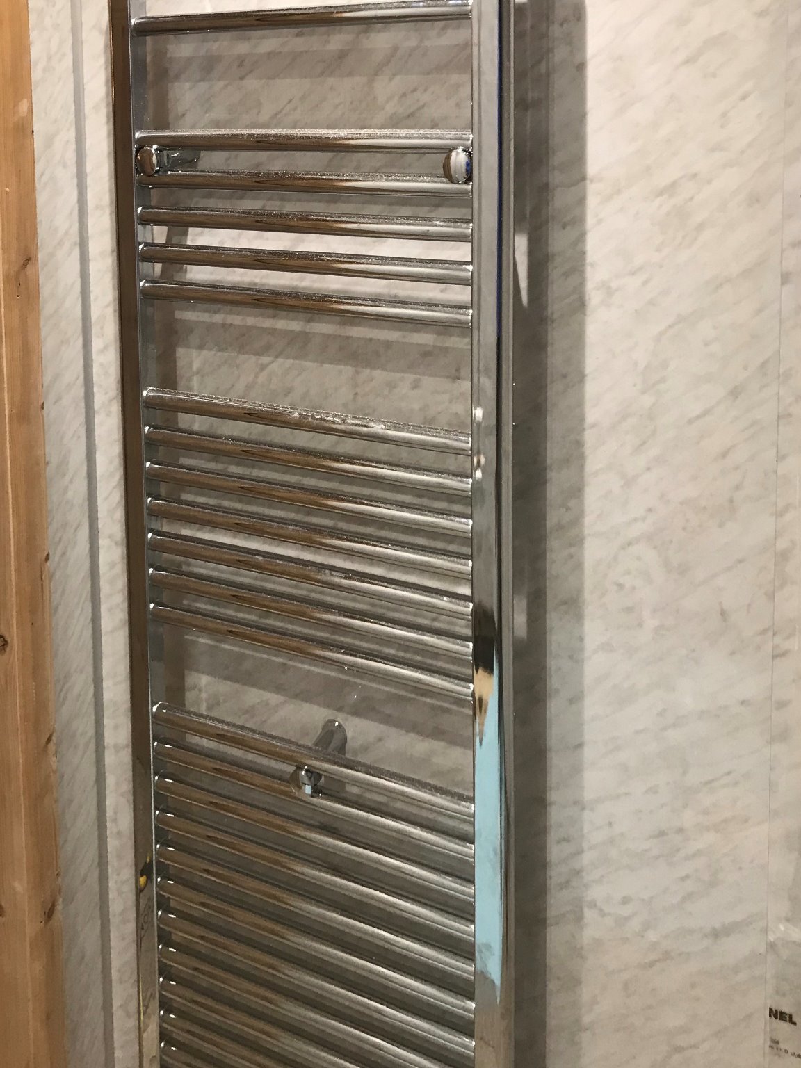 Installation of chrome straight vertical bathroom towel radiator. Barnstaple North Devon