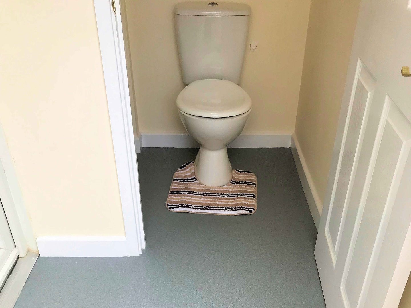 Close coupled toilet installed with Altro nonslip flooring and decorated internals North Devon
