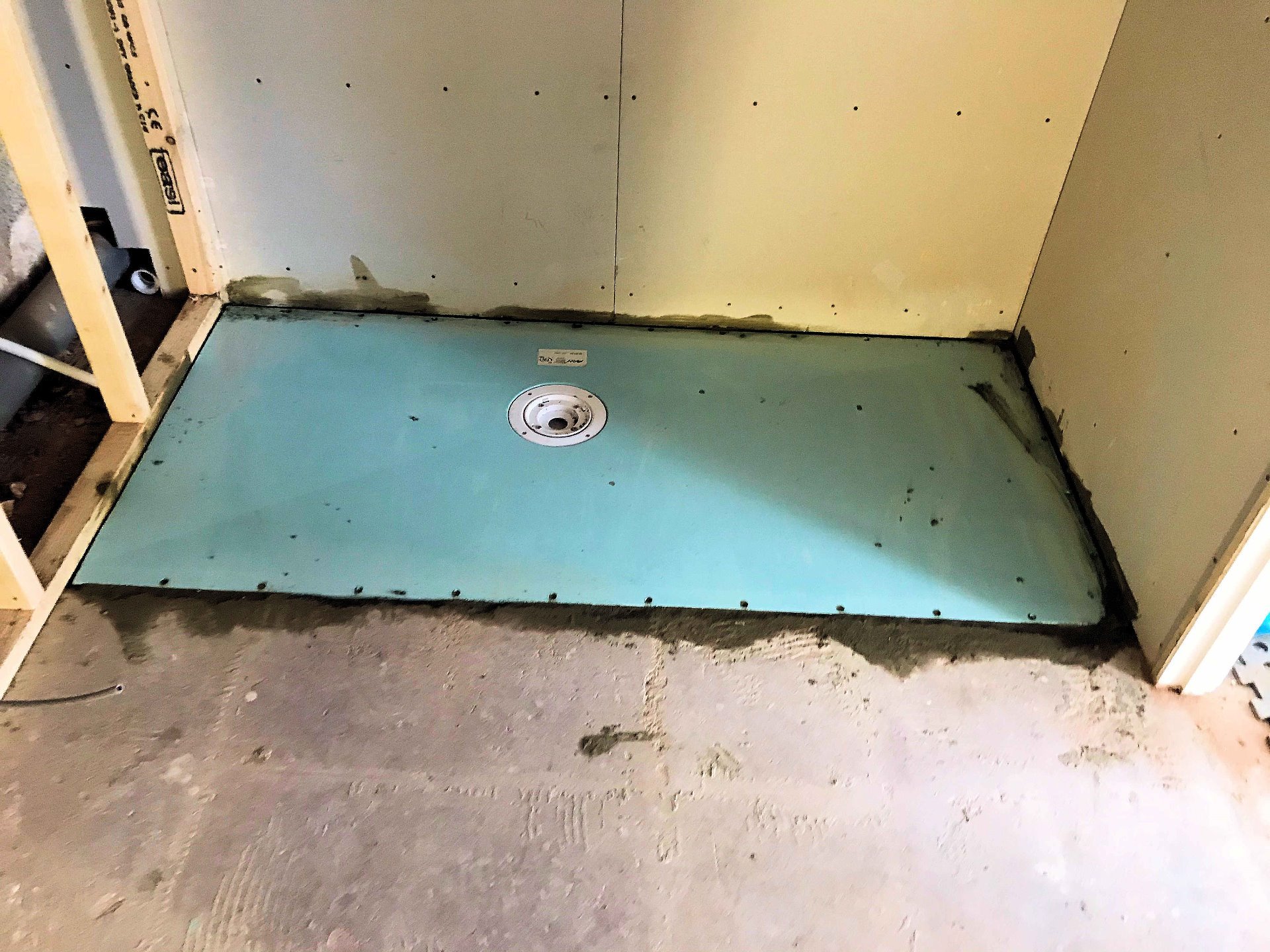 Break out floor to install level shower deck. Wet Room North Devon
