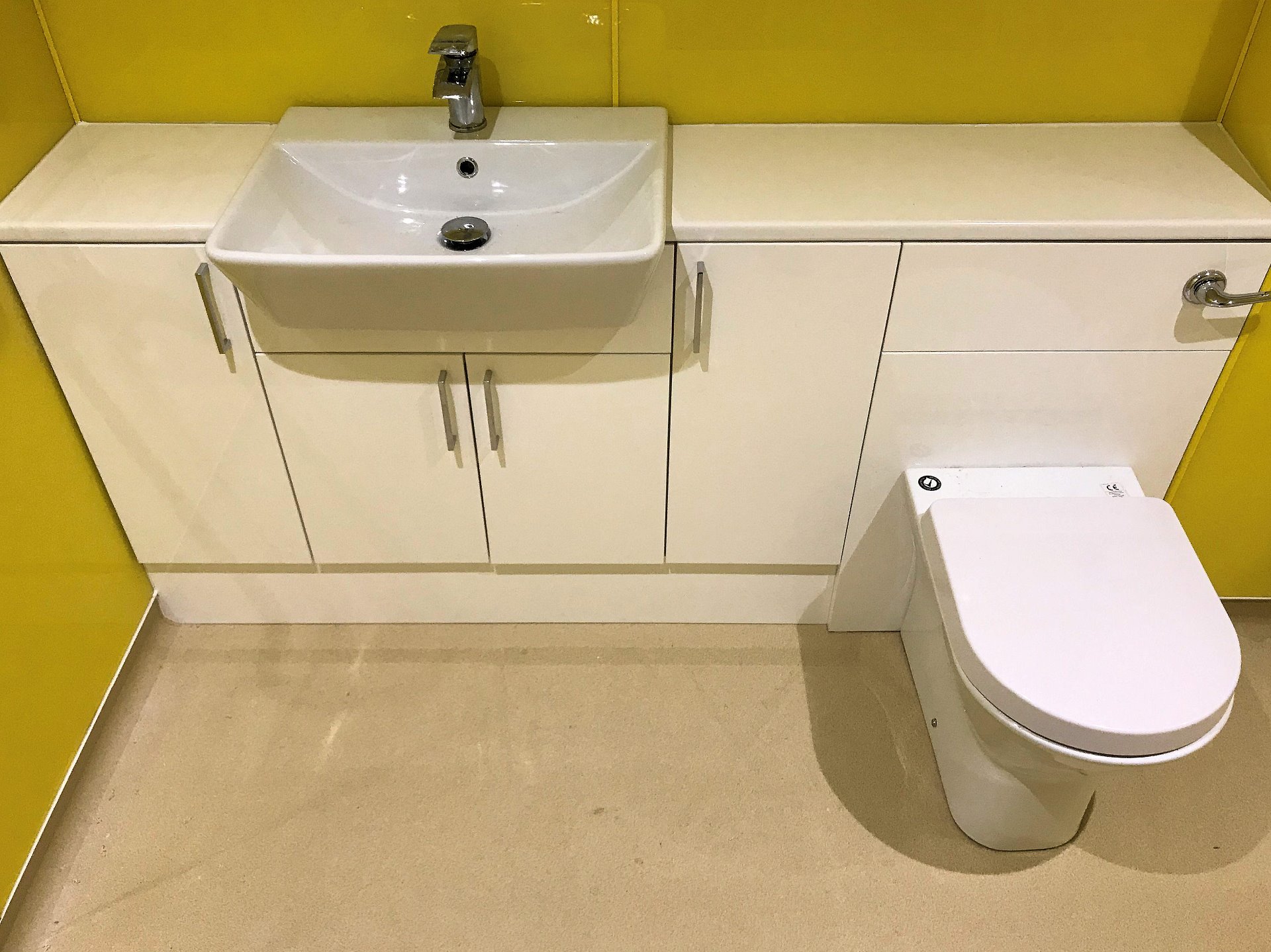 Installation of ceramic white sanitary ware with mono bloc pillar basin mixer tap. Wet Room North Devon
