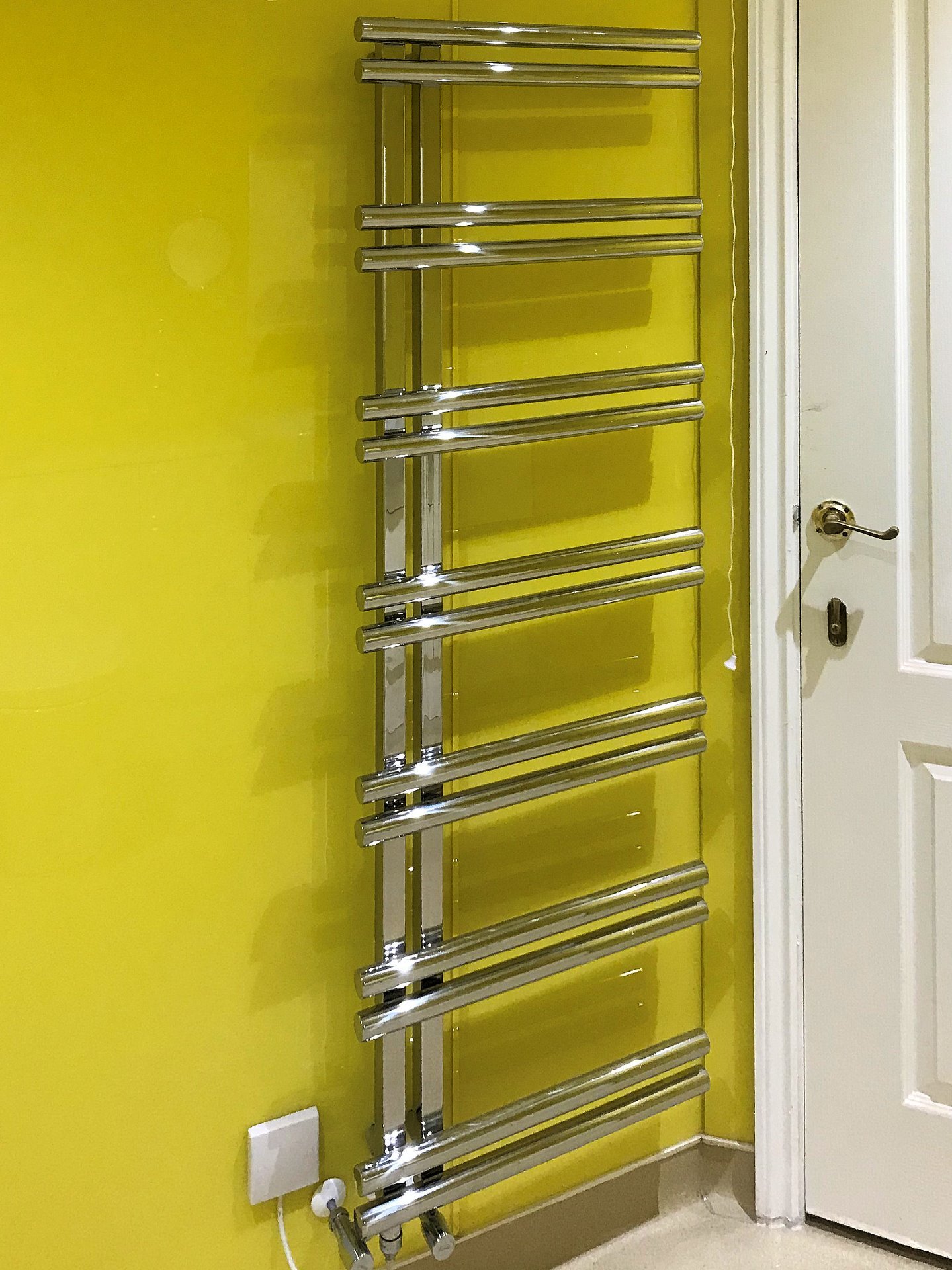 Polished stainless steel designer tall vertical towel warmer radiator. Dual heat water or electric for use through out the year. Wet Room North Devon