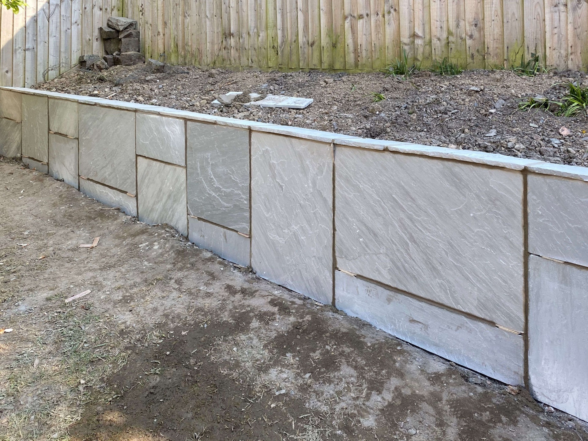Patio Wall Path. Block work retaining wall face clad with Indian sandstone to match patio pattern. Barnstaple North Devon